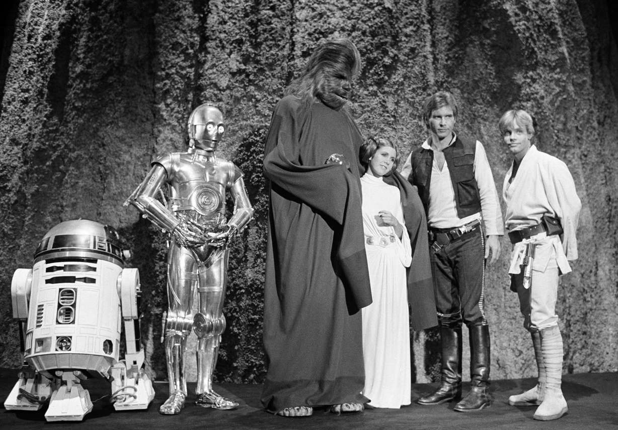 In this Nov. 13, 1978 file photo, shows, from left, Kenny Baker, Anthony Daniels, Peter Mayhew, Carrie Fisher, Harrison Ford, and Mark Hamill during the filming of the CBS-TV special "The Star Wars Holiday" in Los Angeles. On Tuesday, Dec. 27, 2016, a publicist says Fisher has died at the age of 60. (AP Photo/George Brich, File)
