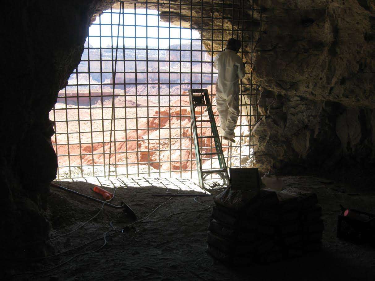 A worker welds a rebar grate closure at the entrance of an abandoned uranium mine portal. The Utah Division of Oil, Gas and Mining is proposing to close 200 mine openings in Tooele County. Another large project was recently completed in the San Rafael region of the state. (Photo: Utah Abandoned Mine Reclamation Program staff, Courtesy Utah Division of Oil, Gas and Mining)