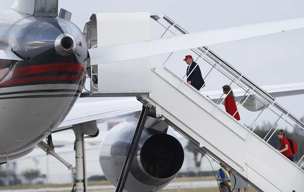 President-elect Donald Trump, followed by his wife Melania Trump and son Barron Trump, boards his plane at Palm Beach International Airport, Sunday, Nov. 27, 2016, in West Palm Beach, Fla., en route to New York. (Carolyn Kaster, AP Photo)