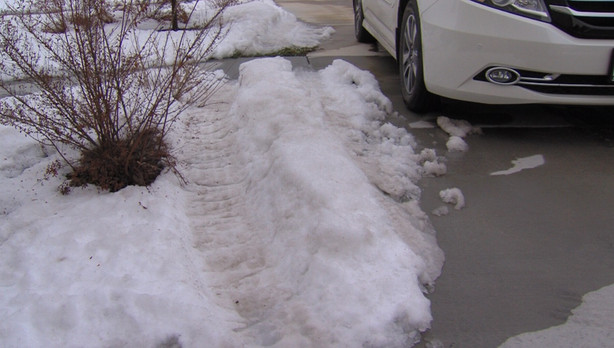 Tire tracks from the stolen 2004 white Toyota Sequoia can be seen in South Jordan on Wednesday, Jan. 4, 2017. The vehicle was stolen from Ashly and Chas Johnson's garage moments before they were to head to the airport to start their vacation in Hawaii. (Photo: KSL TV)