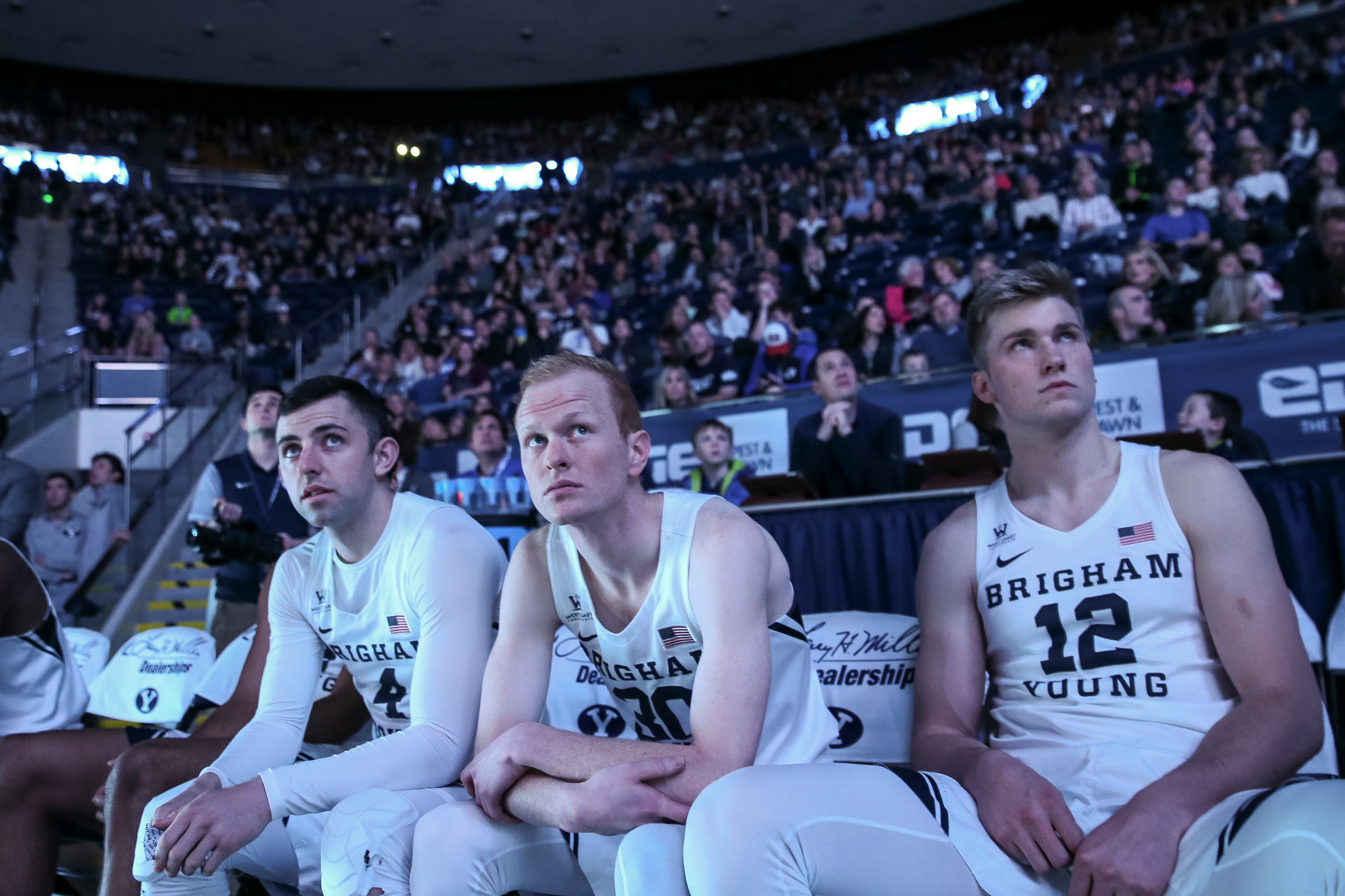 BYU's Nick Emery (4), TJ Haws (30) and Eric Mika (12) watch a highlight reel before the game against the Santa Clara Broncos at the Marriott Center in Provo on Thursday, Dec. 29, 2016. (Photo: Spenser Heaps, Deseret News)