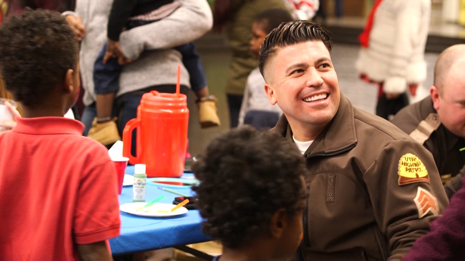 Utah Highway Patrol Sgt. David Moreno Moreno often goes to refugee get-togethers to play with children, talk to adults and let them know he's there for them. (Photo: KSL TV)