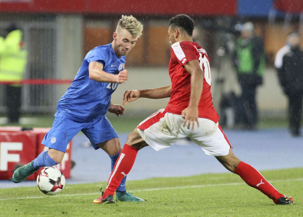 Slovakia's Albert Rusnak and Austria's Karim Onisiwo, from left, challenge for the ball during an international friendly soccer match between Austria and Slovakia in Vienna, Austria, Tuesday, Nov. 15, 2016. (AP Photo, Ronald Zak)