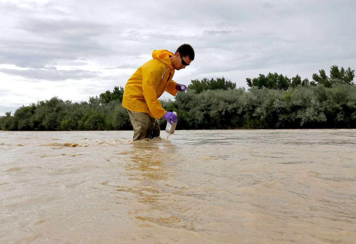 This Aug. 11, 2015, file photo, Hydrologic Technician Ryan Parker gathers water samples from the San Juan River, in Montezuma Creek, Utah. A new report released Monday, June 13, 2016, shows that more than half of Utah lakes and nearly half of streams don't meet water quality standards. (Matt York, AP Photo, File)