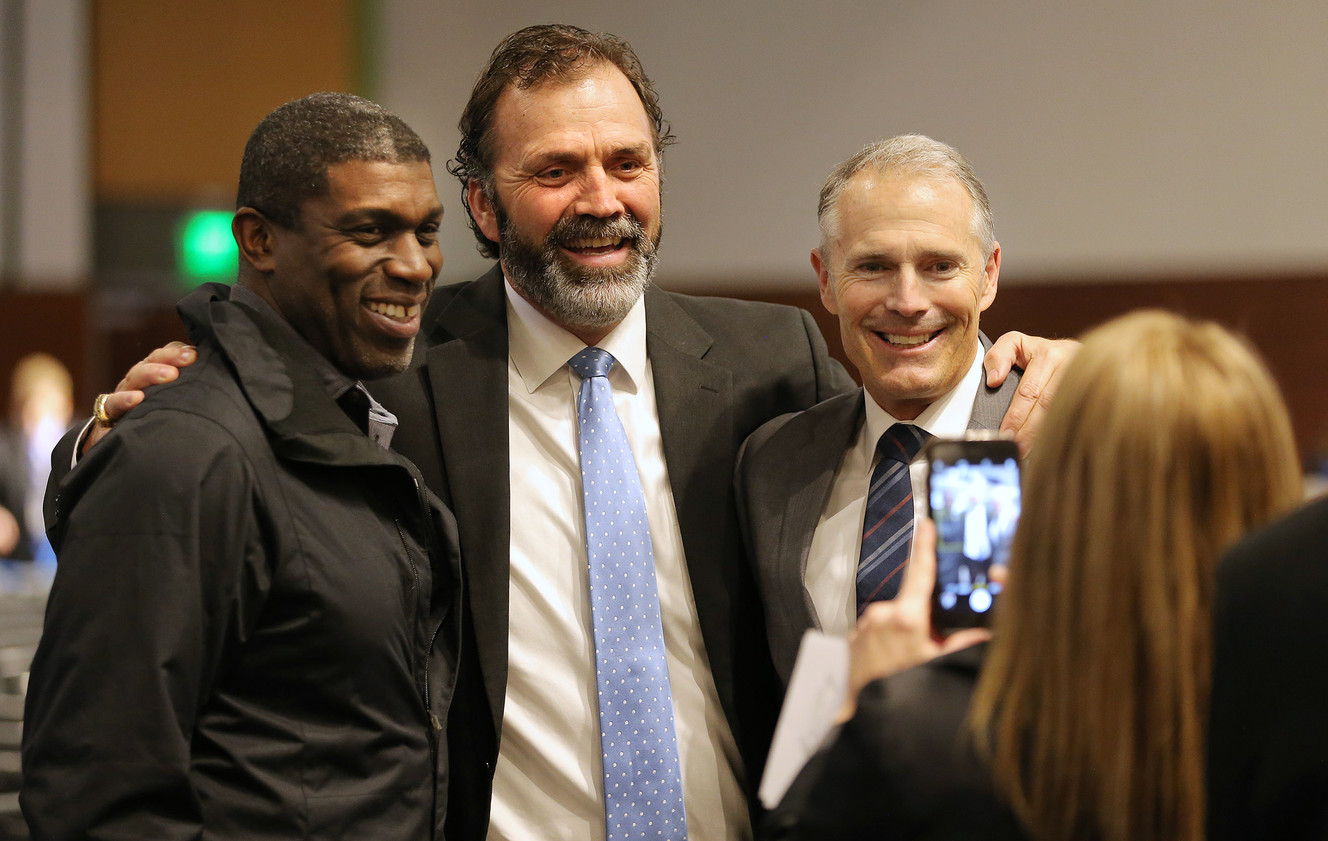 Leon White Jason Buck, and Lee Johnson pose for a photo as family, friends and former team members gather to honor former BYU football coach Lavell Edwards at a memorial service at the Provo Convention Center on Friday, Jan. 6, 2017. (Photo: Scott G Winterton, Deseret News)