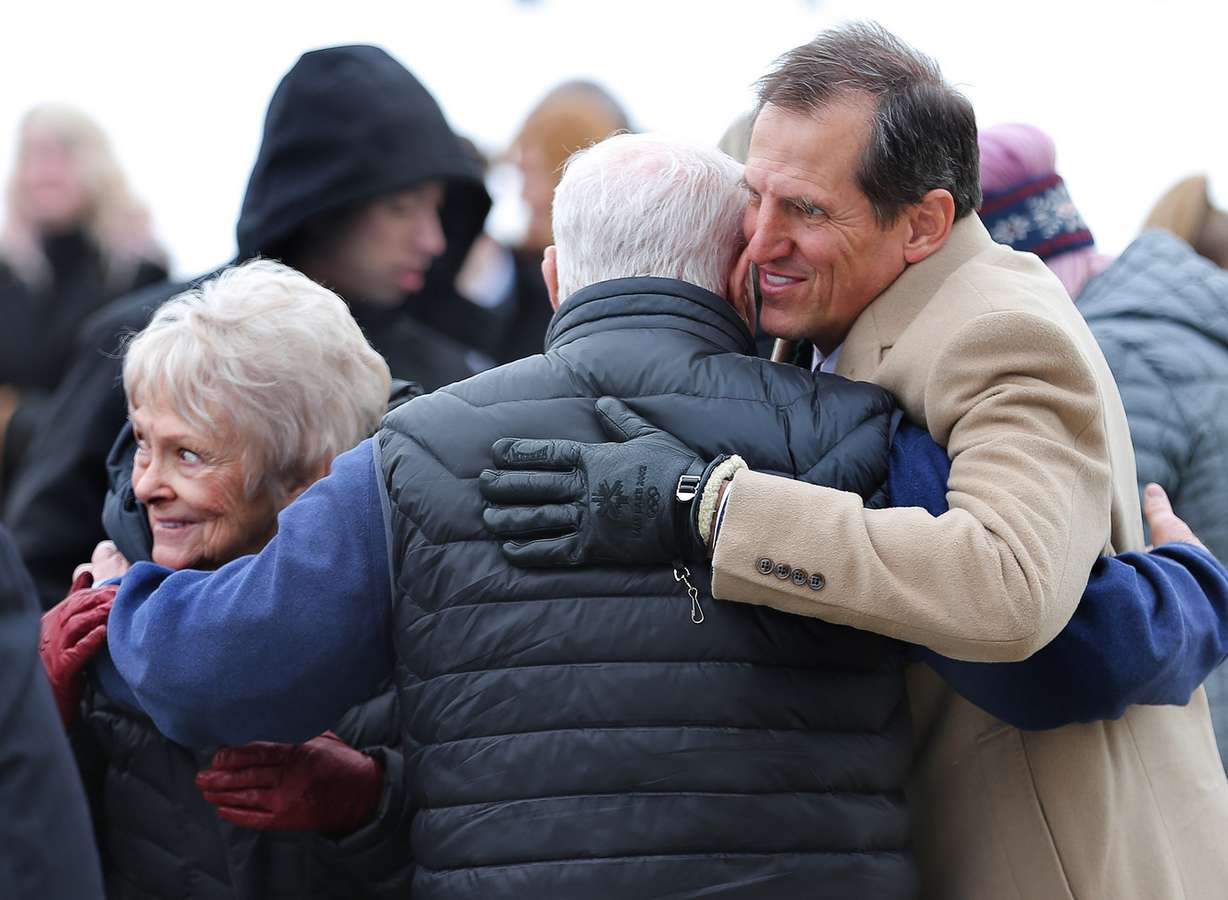 Former University of Utah head football coach Ron McBride hugs Patti Edwards and John Edwards after graveside services at Eastlawn Memorial Hills Cemetery in Provo for former BYU football coach LaVell Edwards on Saturday, Jan. 7, 2017. (Photo: Scott G Winterton, Deseret News)