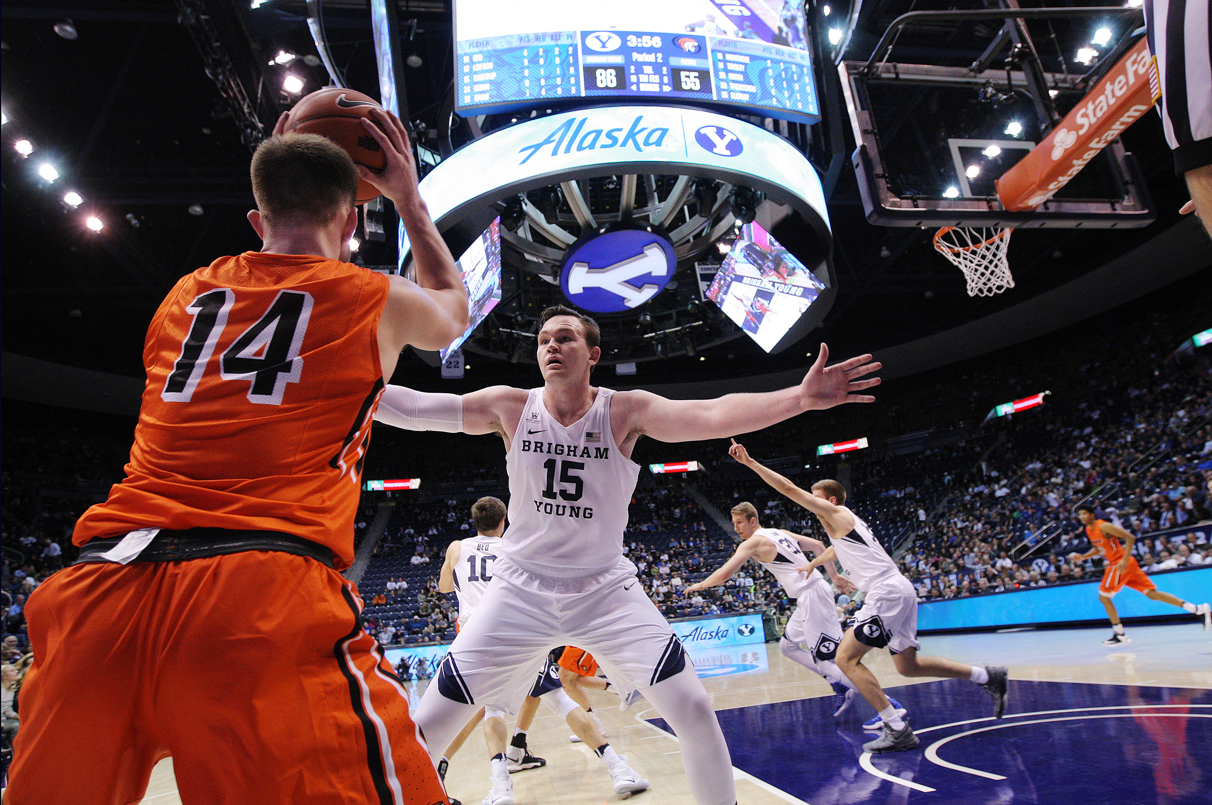 Pacific guard Max Tinsley (14) looks for an open teammate as he is defended by BYU forward Payton Dastrup (15) as BYU and Pacific play at the Marriott Center in Provo on Saturday, Jan. 7, 2017. (Photo: Scott G Winterton, Deseret News)