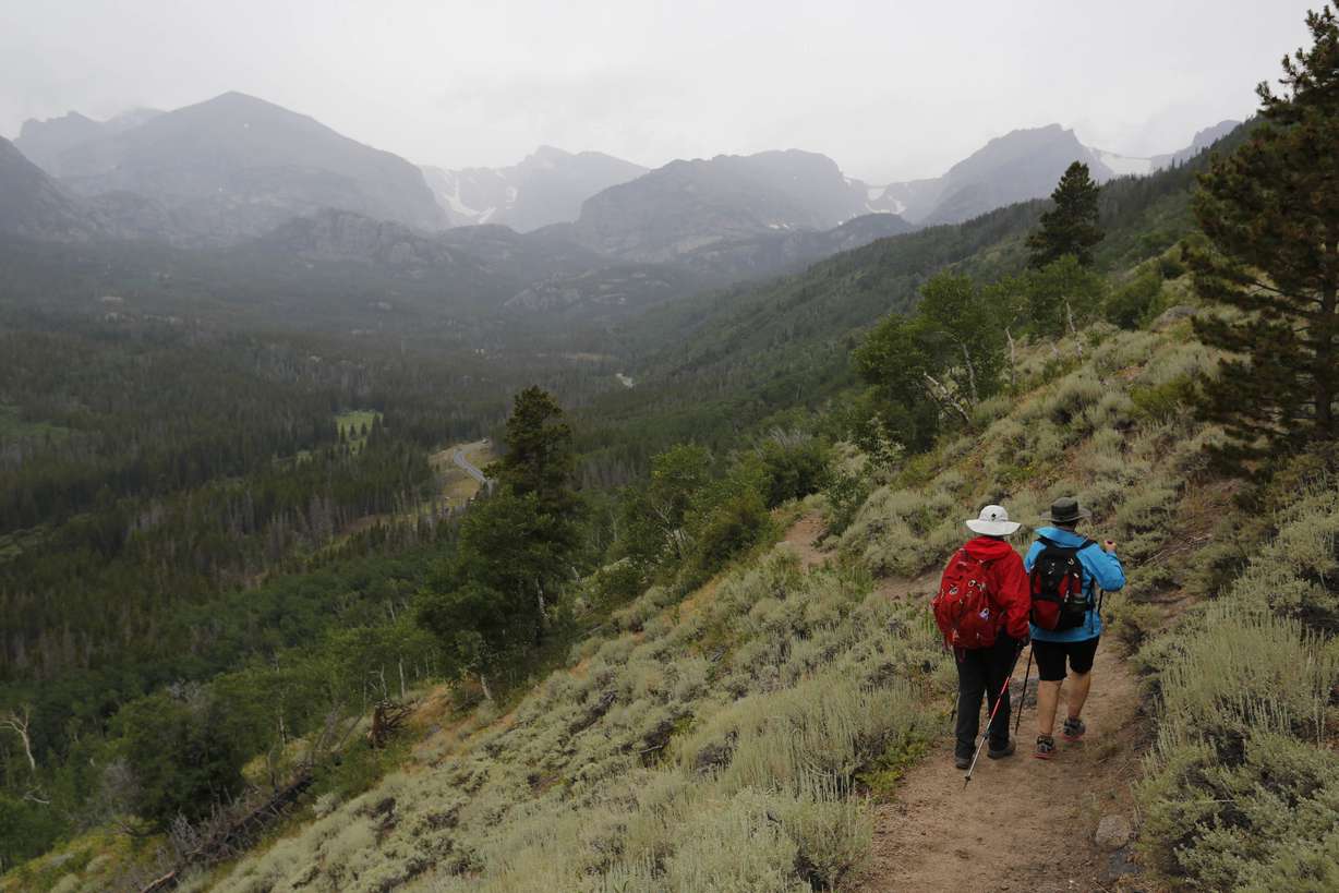 Hikers descend a ridge inside Rocky Mountain National Park, near Estes Park, Colo. Aug. 4, 2016. Photo: Brennan Linsley, AP Photo