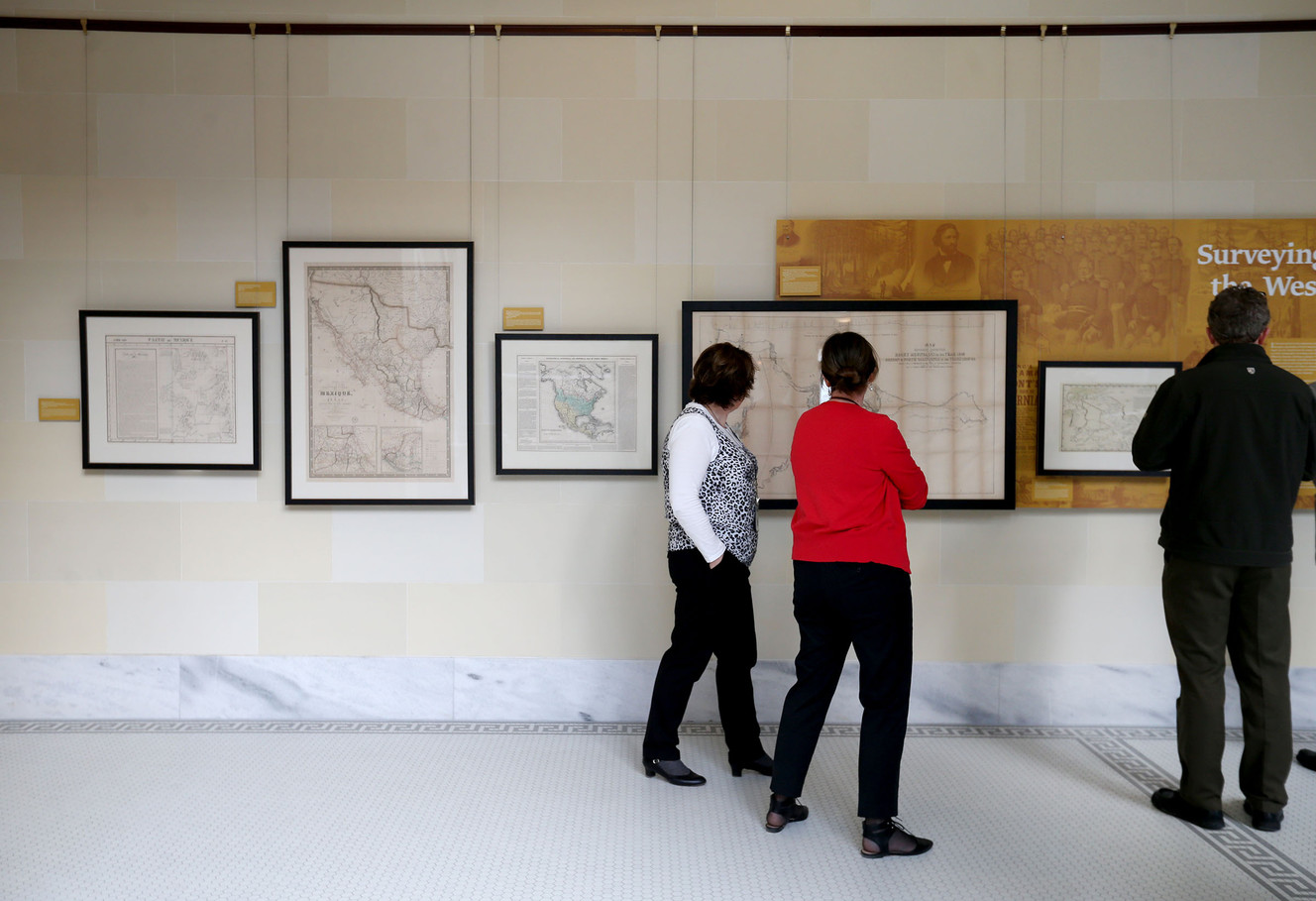 People look at a rare map exhibit on the fourth floor of the Capitol in Salt Lake City on Friday, Jan. 27, 2017. The maps demonstrate the political and economic interests that produced the maps, hinting at what the mapmakers and their sponsors determined was worth documenting, identifying and, in some cases, taking and possessing. (Photo: Laura Seitz, Deseret News)