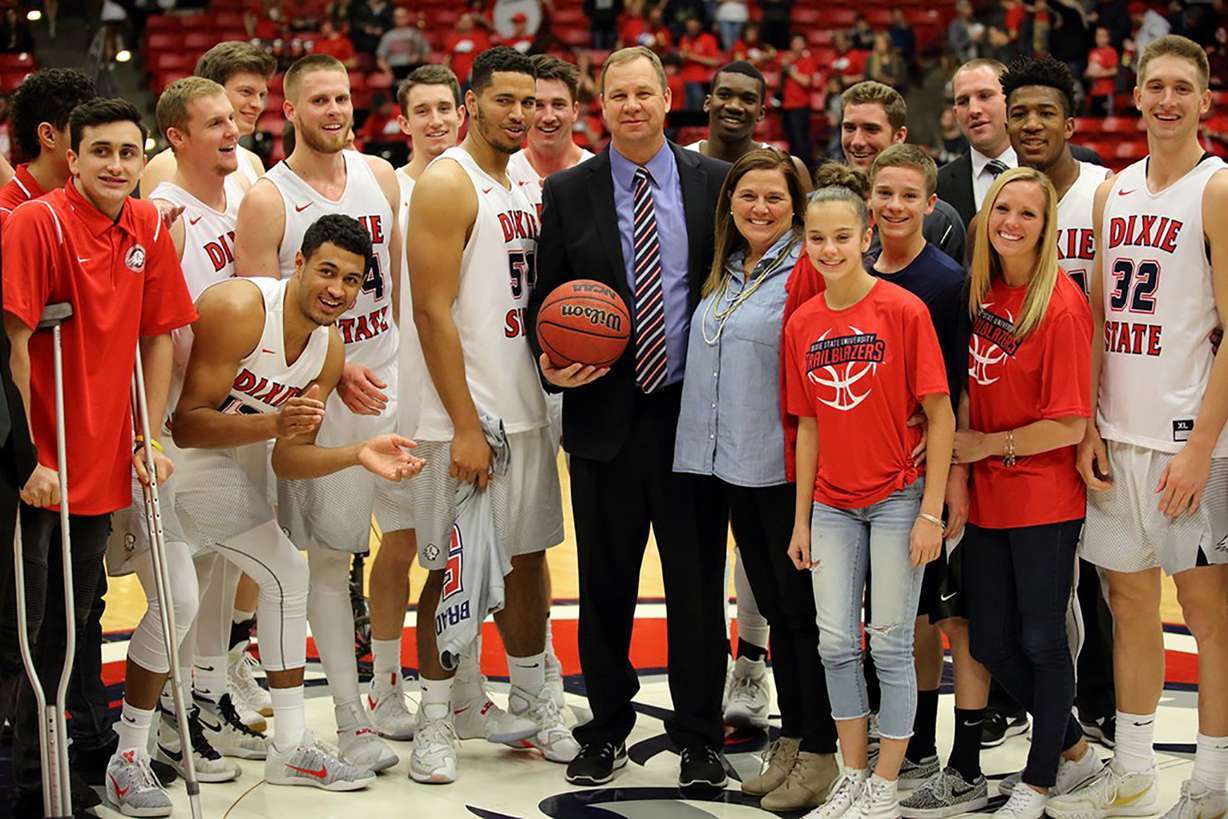 Then-Dixie State head men's basketball coach Jon Judkins (center) celebrates his 500th-career victory with his family and team as the Trailblazers posted an 81-72 win over Hawai'i Hilo Saturday night in St. George.