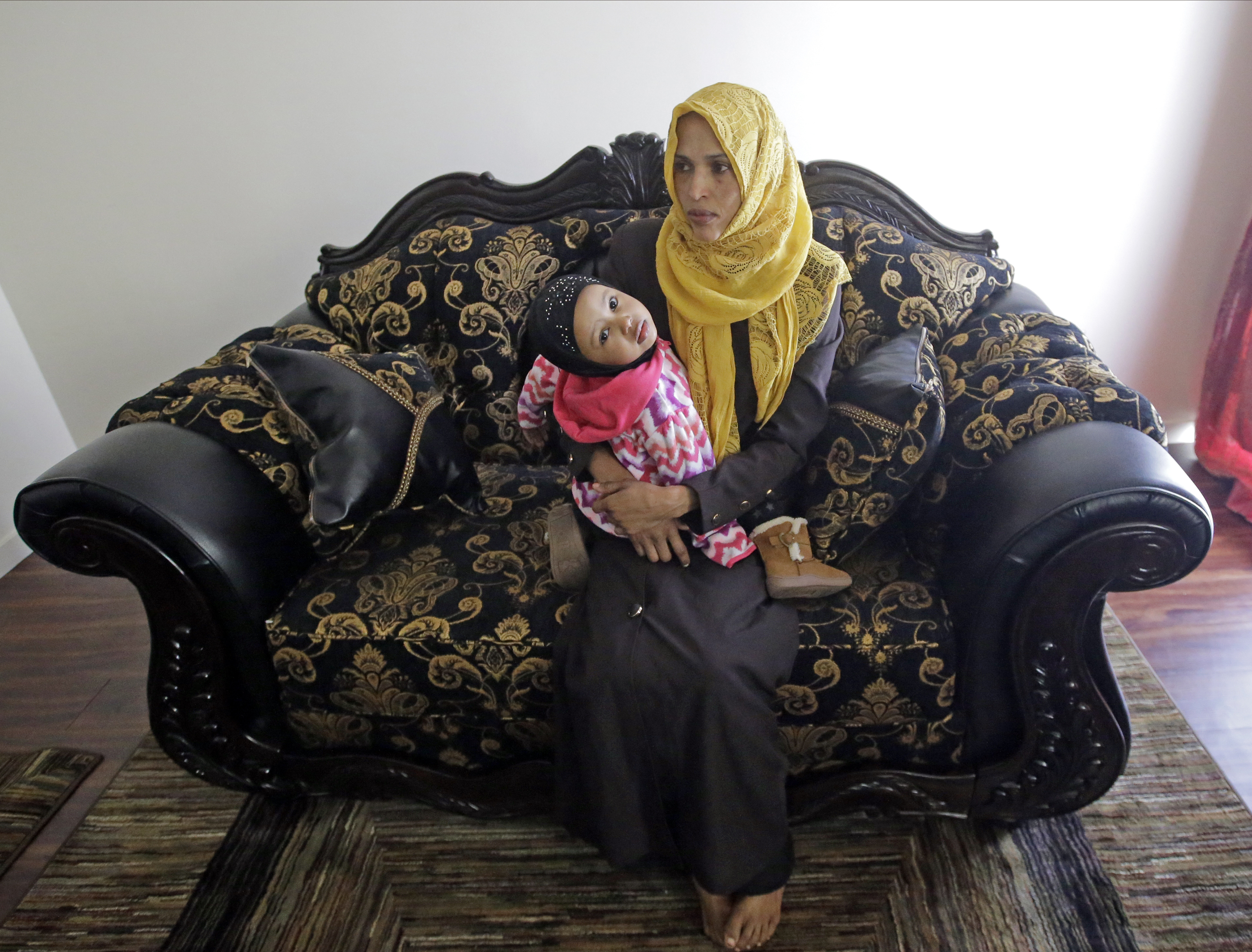 Somali refugee Nimo Hashi sits with her daughter Taslim at their home Tuesday, Jan. 31, 2017, in Salt Lake City. Hashi bought a new kitchen table and couches for her Salt Lake City apartment in joyful anticipation of reuniting Friday with her husband for the first time in nearly three years. (Photo: Rick Bowmer, AP Photo)
