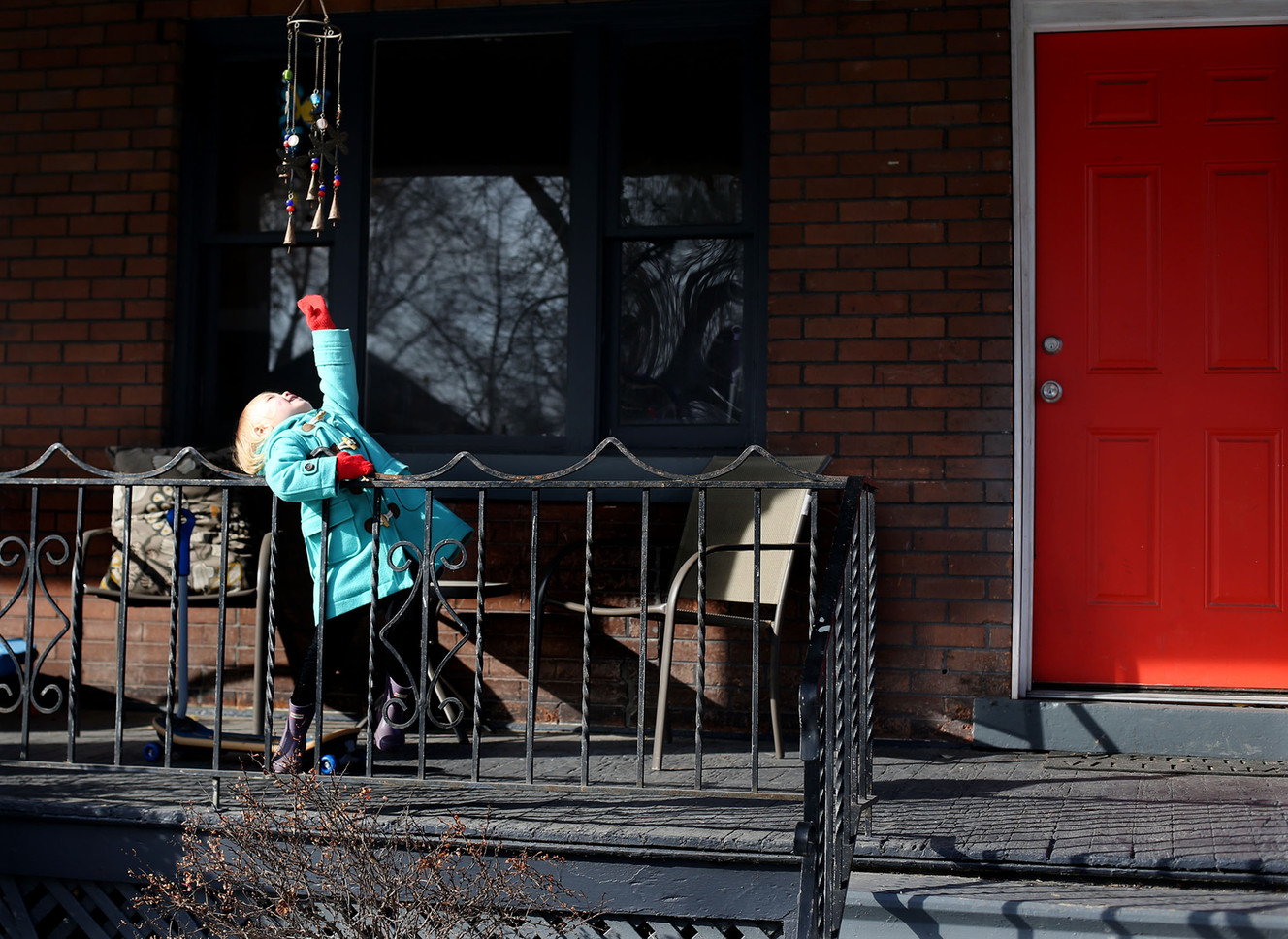 Emmarose Pacheco, 3, reaches for wind chimes at her home in Salt Lake City on Wednesday, Feb. 1, 2017. The Pachecos took advantage of Salt Lake County's lead-based paint cleanup program.