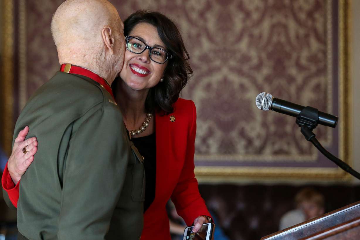 Col. Gail Halvorsen, nicknamed the "The Candy Bomber," and Sen. Deidre Henderson, R-Spanish Fork, embrace during a ceremony honoring Halvorsen in the Gold Room at the Capitol in Salt Lake City on Friday, Feb. 3, 2017. (Photo: Spenser Heaps, Deseret News)