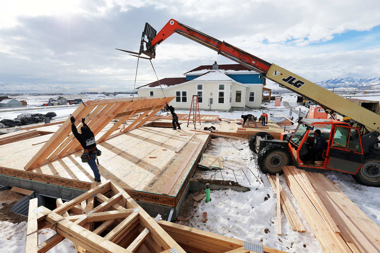 Workers from Dawson building systems put up a wall of a home being built in Daybreak on Friday, Feb. 3, 2017. (Photo: Scott G Winterton, Deseret News)