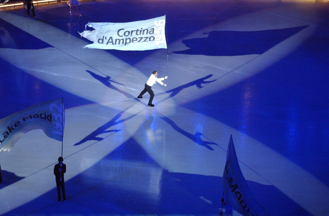 A lone skater carries a flag during the Salt Lake 2002 Olympic Winter Games Opening Ceremony at Rice-Eccles Stadium, Friday, Feb 8, 2002. (Photo: Johanna Workman, Deseret News, File)