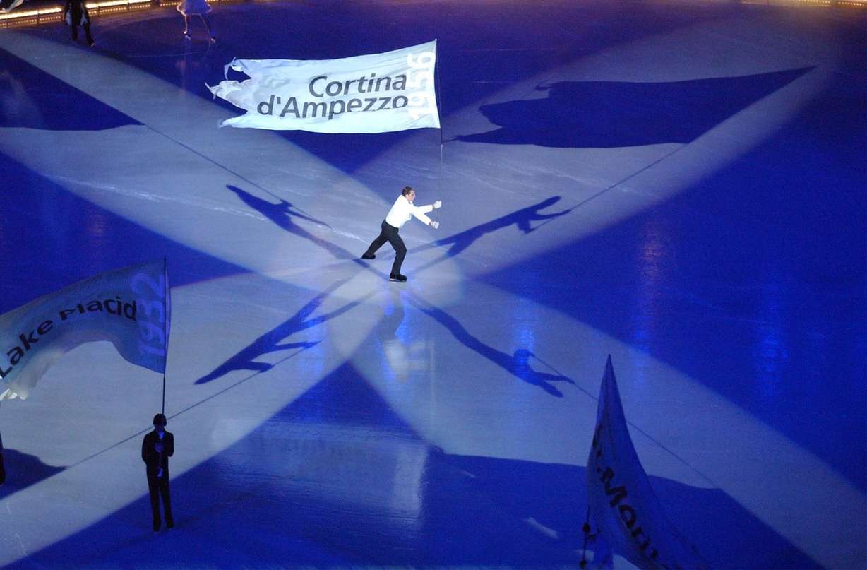 A lone skater carries a flag during the Salt Lake 2002 Olympic Winter Games Opening Ceremony at Rice-Eccles Stadium, Friday, Feb 8, 2002. (Photo: Johanna Workman, Deseret News, File)