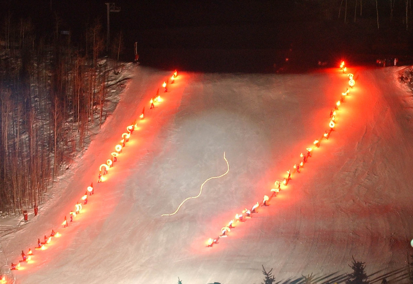 The Olympic Flame appears as a small line of light as it makes its way down Pepi's Face on International in Vail, Colorado. (Photo: Scott G. Winterton, Deseret News, File)