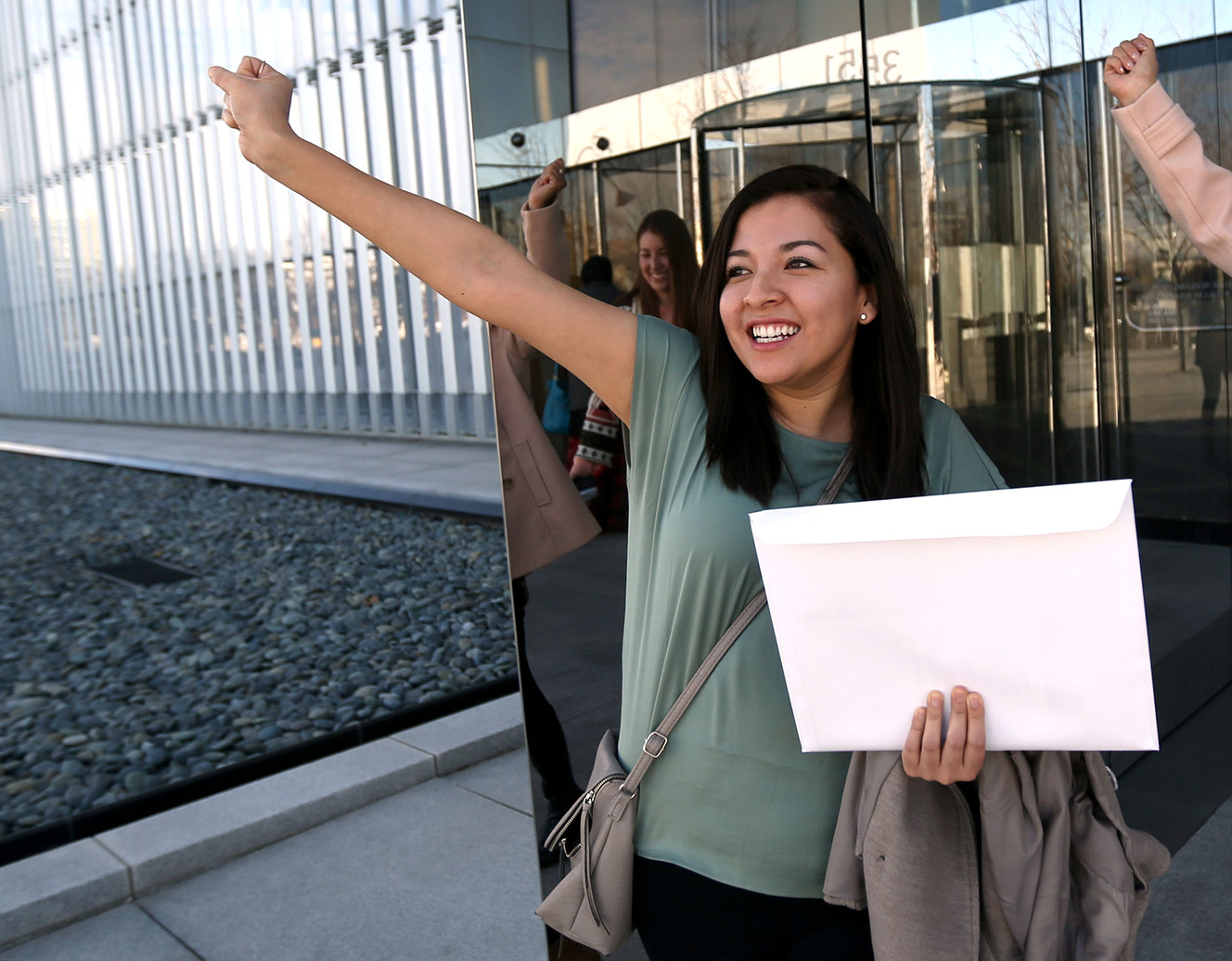 Katherine Portocarrero, from Peru, celebrates after becoming an American citizen during a naturalization ceremony at the federal courthouse in Salt Lake City on Wednesday, Feb. 8, 2017. Her sister, Pamela Portocarrero, who does not have legal status in the United States, worries she could face deportation if the Trump administration strikes the Deferred Action for Childhood Arrivals program. (Photo: Kristin Murphy, Deseret News)