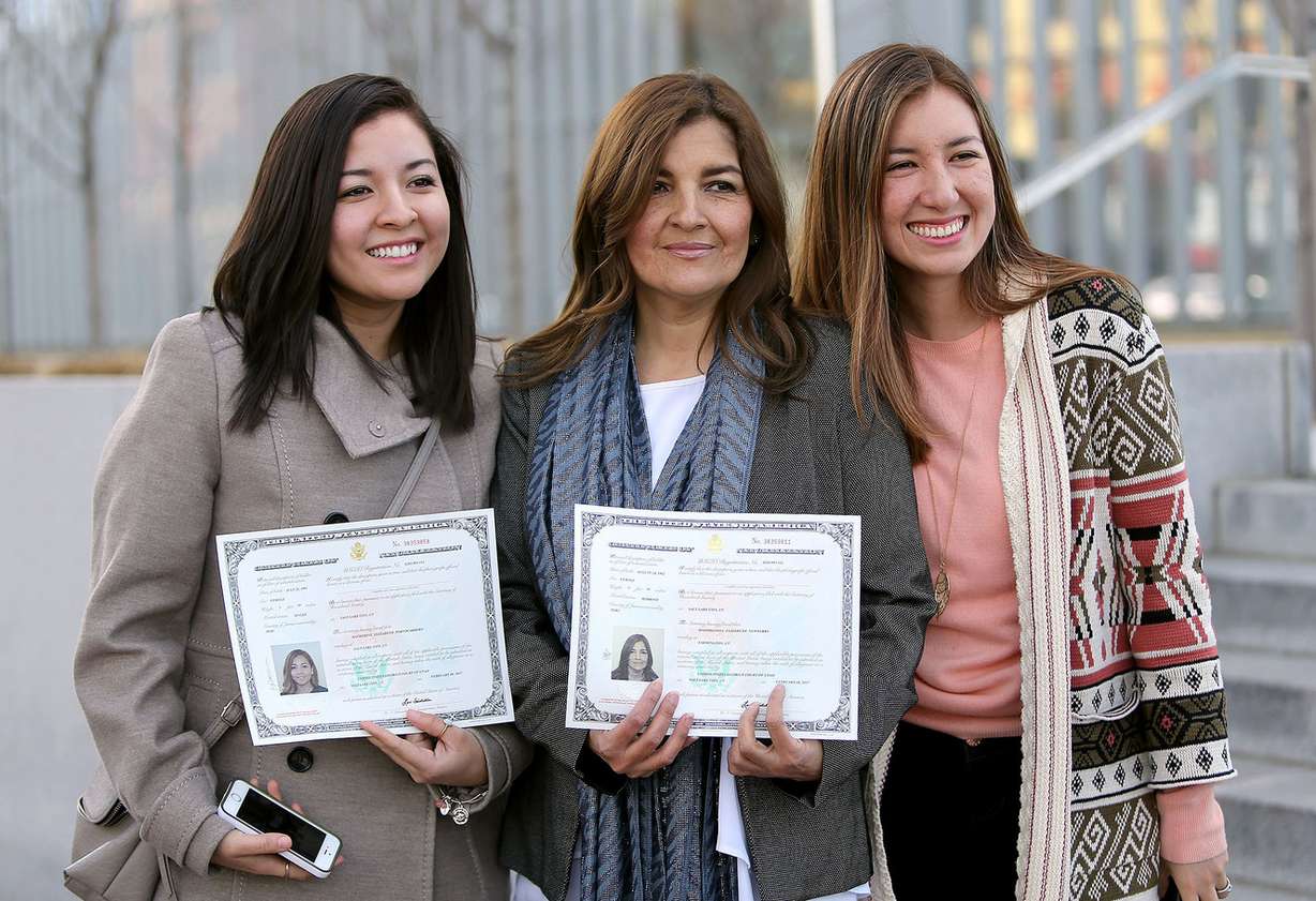 Elizabeth Newberry, center, and daughters Katerine Portocarrero, left, and Pamela Portocarrero, right, pose for a photo outside the federal courthouse in Salt Lake City on Wednesday, Feb. 8, 2017, after Katherine and Elizabeth became American citizens during a naturalization ceremony. Pamela Portocarrero, who does not have legal status in the United States, worries she could face deportation if the Trump administration strikes the Deferred Action for Childhood Arrivals program. (Photo: Kristin Murphy, Deseret News)
