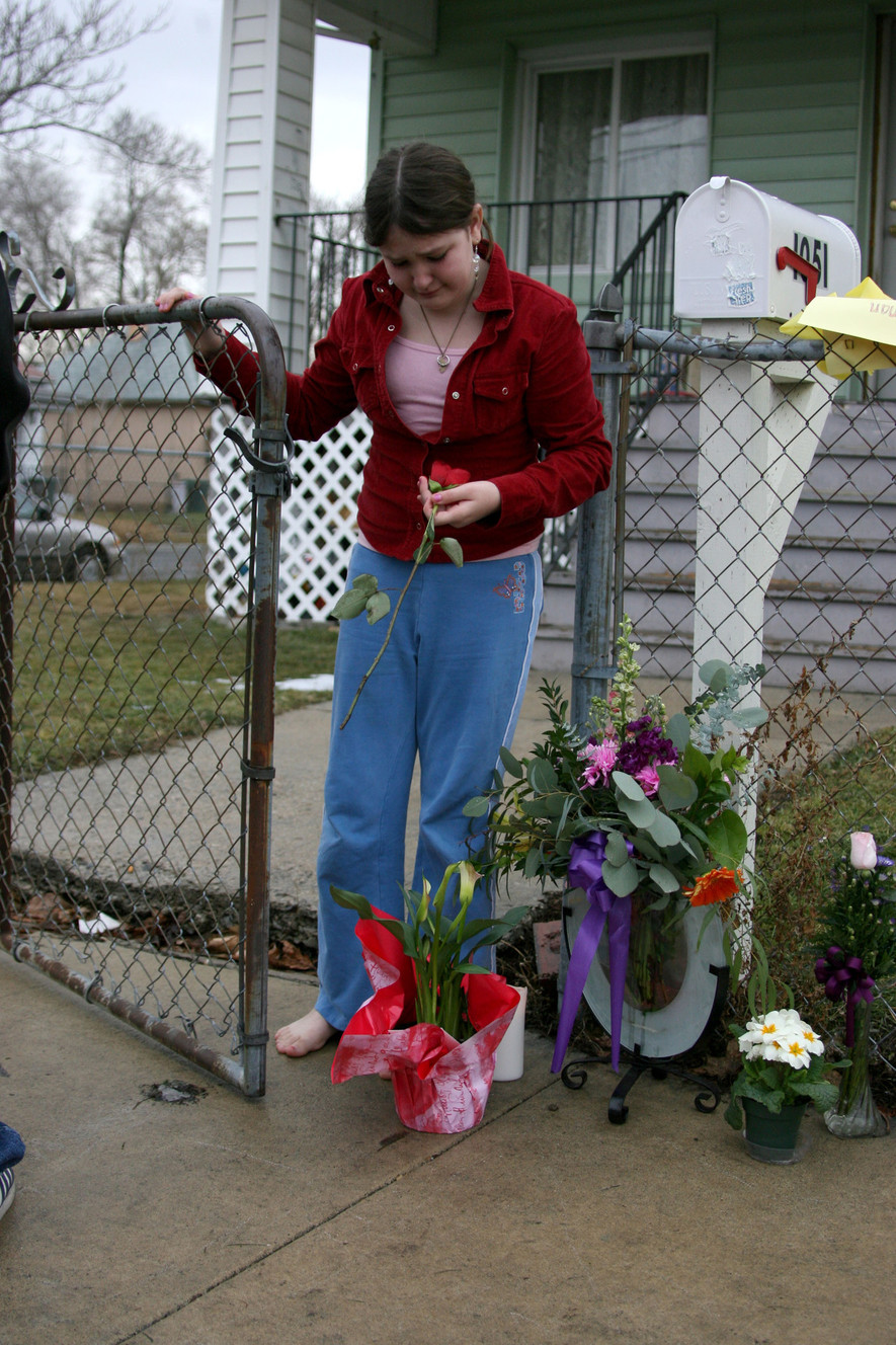 9-year-old Fatima Talovic sister of Sulejman Talovic, picks a flower from the bouquets left at the family's home on February 15, 2007. (Photo: Michael Brandy, Deseret News, File)