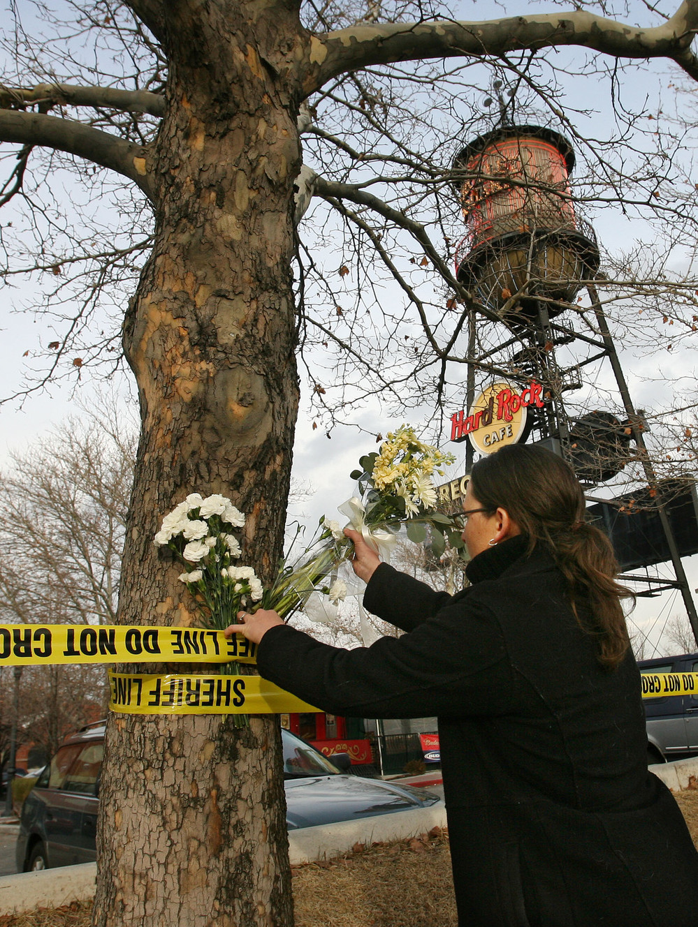 Jessica Kirby leaves flowers in the police tape at Trolley Square in Salt Lake City Feb 13, 2007 after gunman killed five people. Police killed the gunman. (Photo: Jeffrey D. Allred, Deseret News, File)