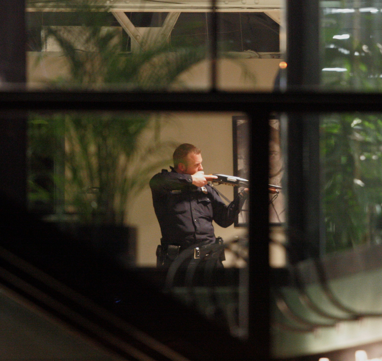 An SLCPD officer with a gun drawn inside the mall after a gunman opened fire in the Trolley Square shopping mall in Salt Lake City, Utah, Feb. 12, 2007. (Photo: Mike Terry, Deseret News, File)