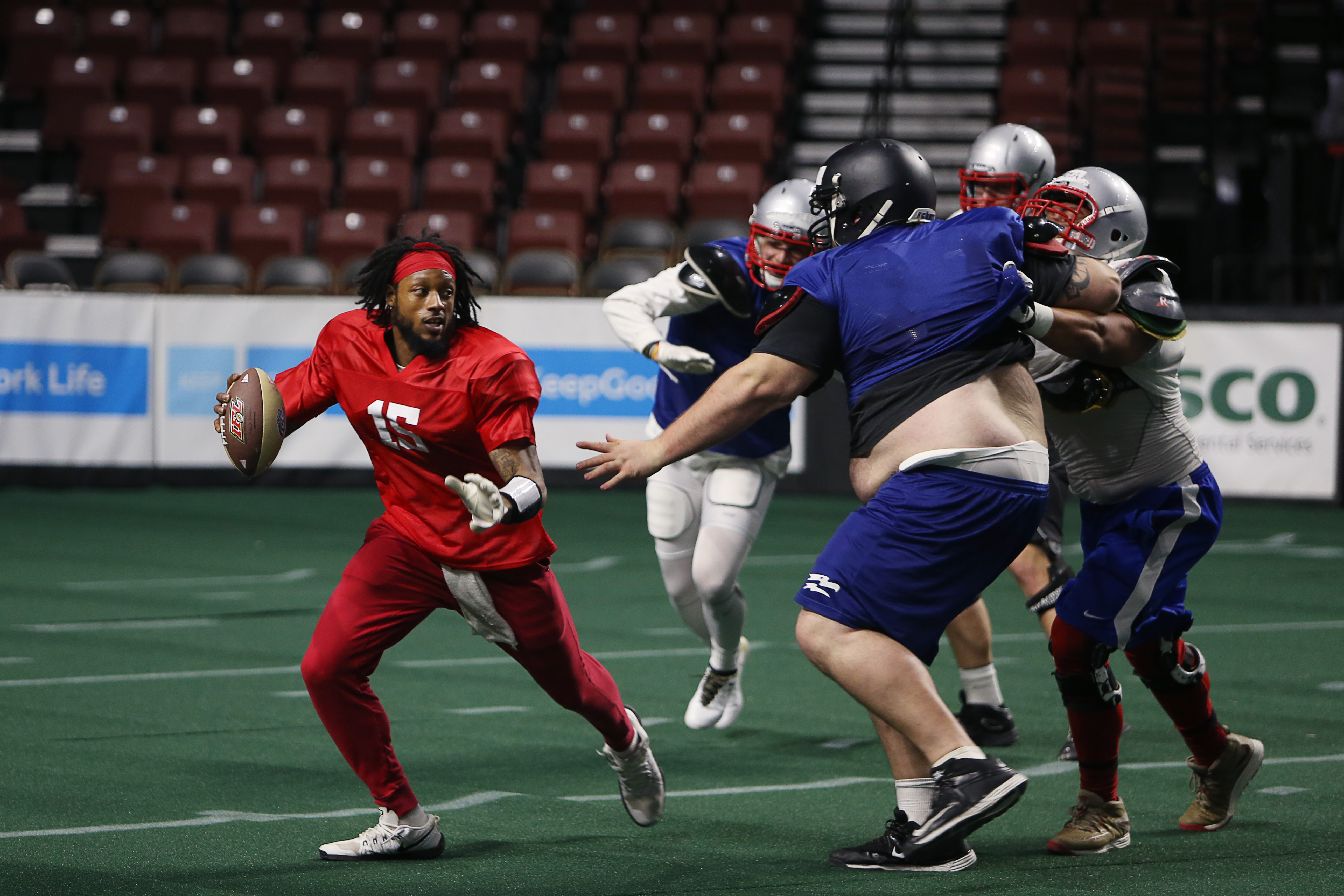 Screaming Eagles quarterback Verlon Reed evades defenders during a recent practice at the Maverik Center. (Photo: Melissa Majchrzak , Salt Lake Screaming Eagles)