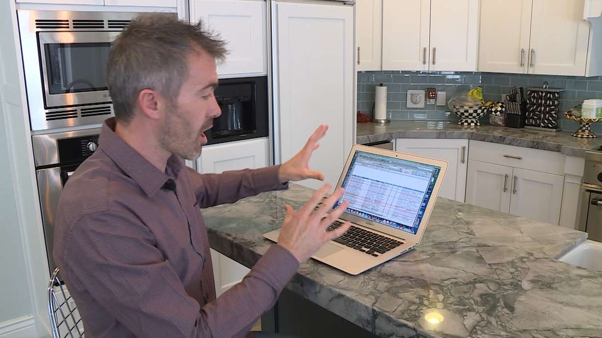 Derek Tillotson shows the family's spreadsheet of applicants. (Photo: Ray Boone, KSL TV)