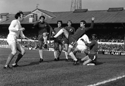 In this Oct. 18, 1969 file photo, Chelsea's Eddie McCreadie, second right, kicks clear from scrimmage in front West Bromwich's Jeff Astle, left, during the English League Division one soccer match between Chelsea and West Bromwich Albion at Stamford Bridge Stadium in London. (AP Photo/Robert Rider, file)
