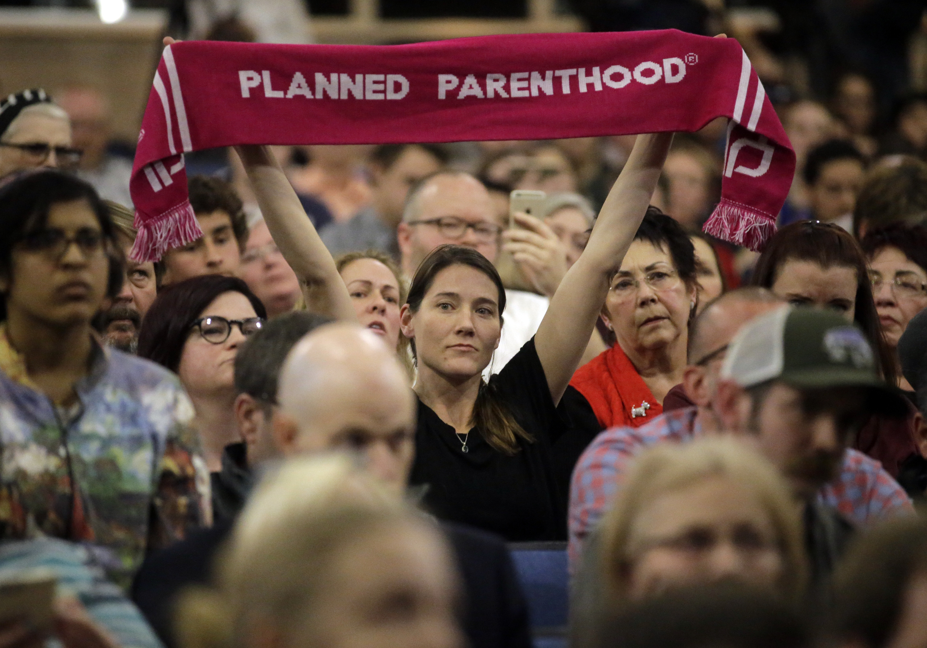 In this Feb. 9, 2017, file photo, a person supporting Planned Parenthood looks on during Rep. Jason Chaffetz's town hall meeting at Brighton High School in Cottonwood Heights, Utah. Sixteen states ban abortions starting at about 20 weeks, according to Guttmacher Institute, a research organization that supports abortion rights. Utah allows such procedures, but last year passed the first law in the nation to require anesthesia or painkillers for fetuses after 20 weeks. Planned Parenthood Association of Utah CEO Karrie Galloway says her doctors are trying to comply with the law, but there is no clear guidance in the law or from state officials on how to do so. (Rick Bowmer, AP Photo, File)