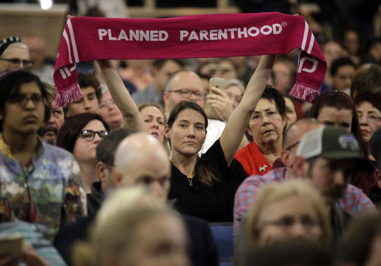 In this Feb. 9, 2017, file photo, a person supporting Planned Parenthood looks on during Rep. Jason Chaffetz's town hall meeting at Brighton High School in Cottonwood Heights, Utah. Sixteen states ban abortions starting at about 20 weeks, according to Guttmacher Institute, a research organization that supports abortion rights. Utah allows such procedures, but last year passed the first law in the nation to require anesthesia or painkillers for fetuses after 20 weeks. Planned Parenthood Association of Utah CEO Karrie Galloway says her doctors are trying to comply with the law, but there is no clear guidance in the law or from state officials on how to do so. (Rick Bowmer, AP Photo, File)