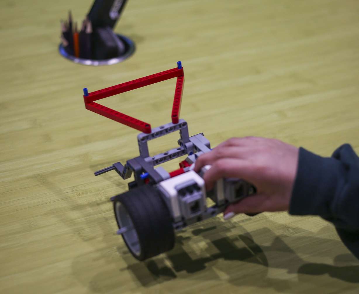 Paloma Velazquez plays with a robot made of Lego blocks during Lego Camp at Zaniac Learning in Salt Lake City on Monday, Feb. 20, 2017. (Photo: Nicole Boliaux, Deseret News)