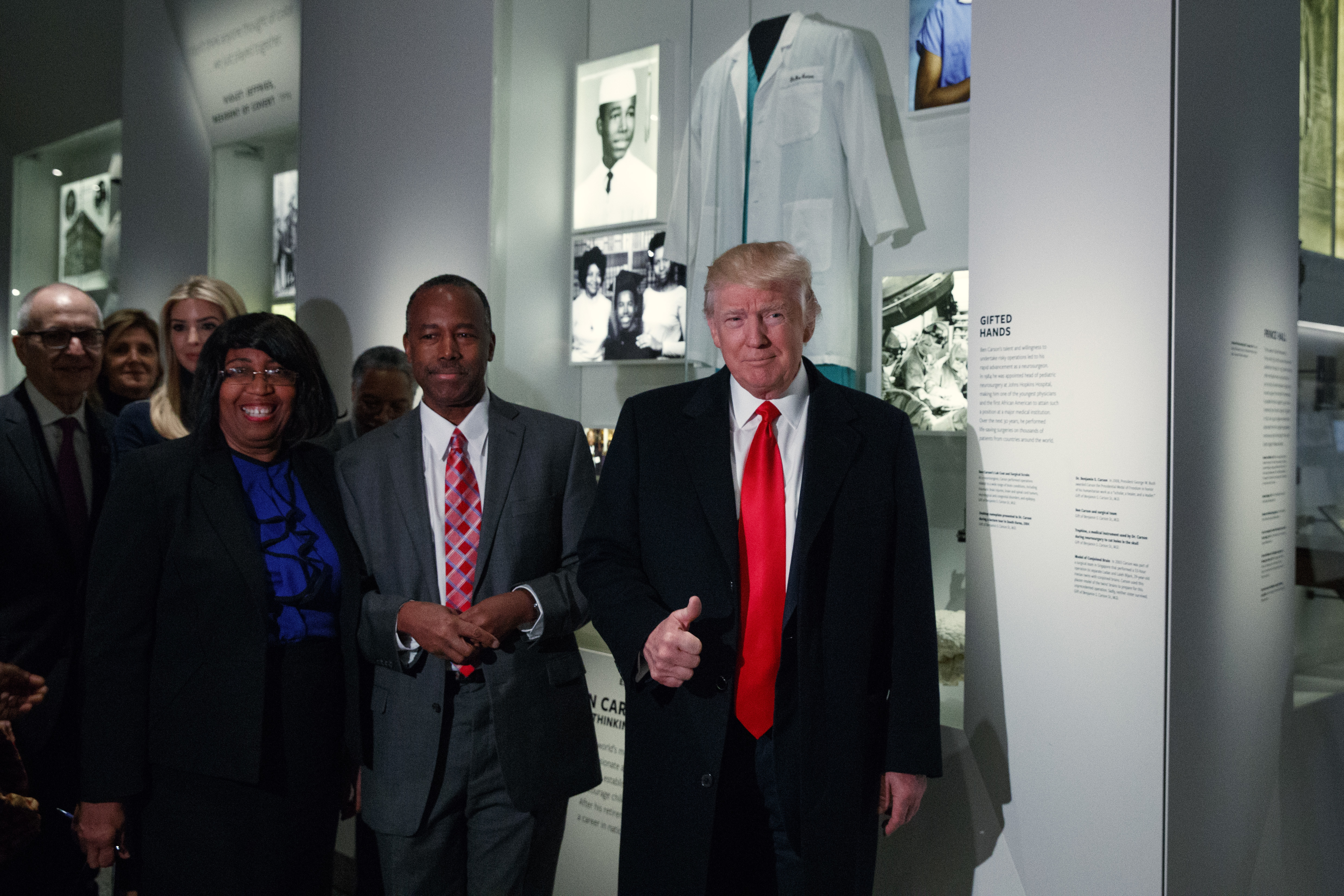 President Donald Trump walks with Housing and Urban Development Secretary-designate Dr. Ben Carson, as they pass a exhibit honoring Carson during a tour of the National Museum of African American History and Culture, Tuesday, Feb. 21, 2017, in Washington. (AP Photo/Evan Vucci)