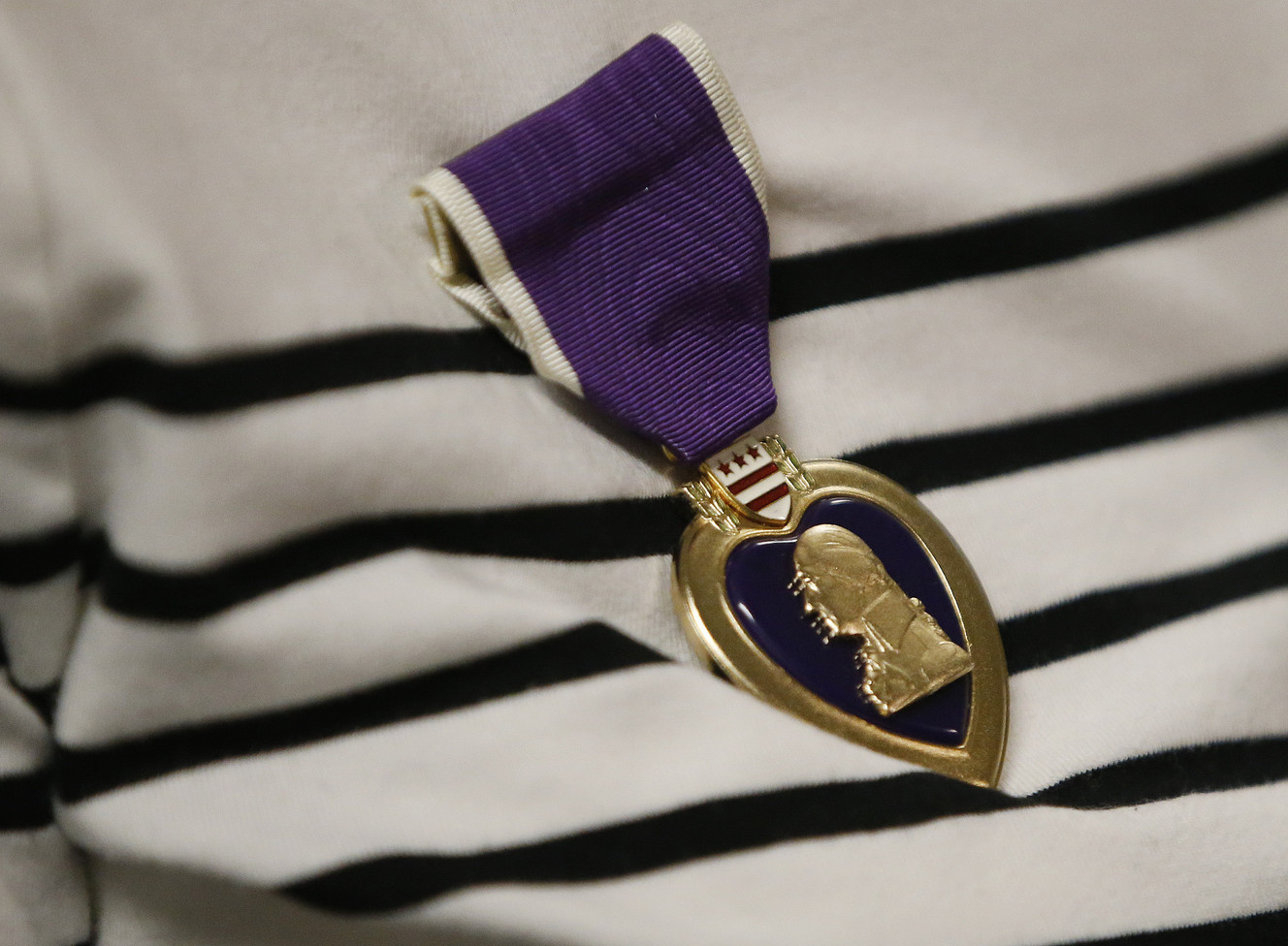 Trish Eckman, daughter of Staff Sgt. Royce Fuhriman, wears her father's Purple Heart in Salt Lake City on Tuesday, Feb. 21, 2017. The medal was awarded posthumously by Sen. Orrin Hatch, R-Utah. Fuhriman was taken prisoner in World War II and survived the Bataan Death March. He died in 2007 at age 86. (Photo: Jeffrey D. Allred, Deseret News)