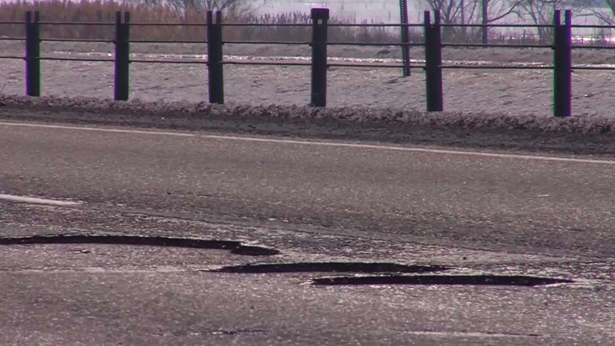 On Redwood Road just north of Bangerter Highway, there's a stretch of potholes in the northbound lane that lasts more than a mile. (Photo: Stuart Johnson, KSL TV)