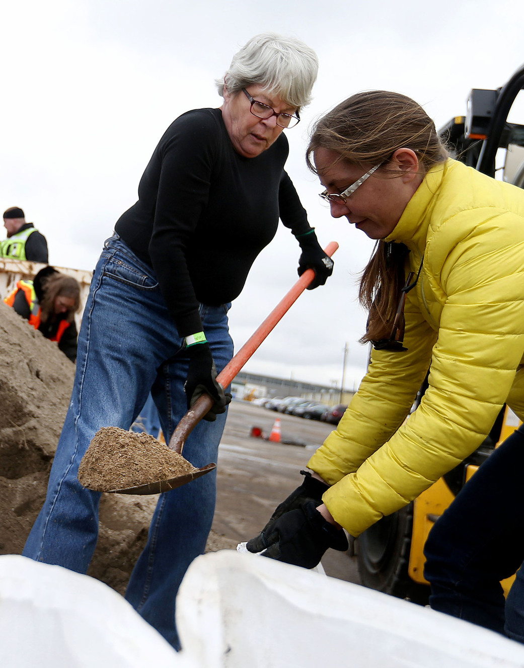 Marjorie Seward and Tiffin Brough fill sandbags at Salt Lake County Public Works Highway Engineering in Midvale on Wednesday, Feb. 22, 2017. The bags were transported to Box Elder County where flooding has been a problem for days. (Photo: Laura Seitz, Deseret News)