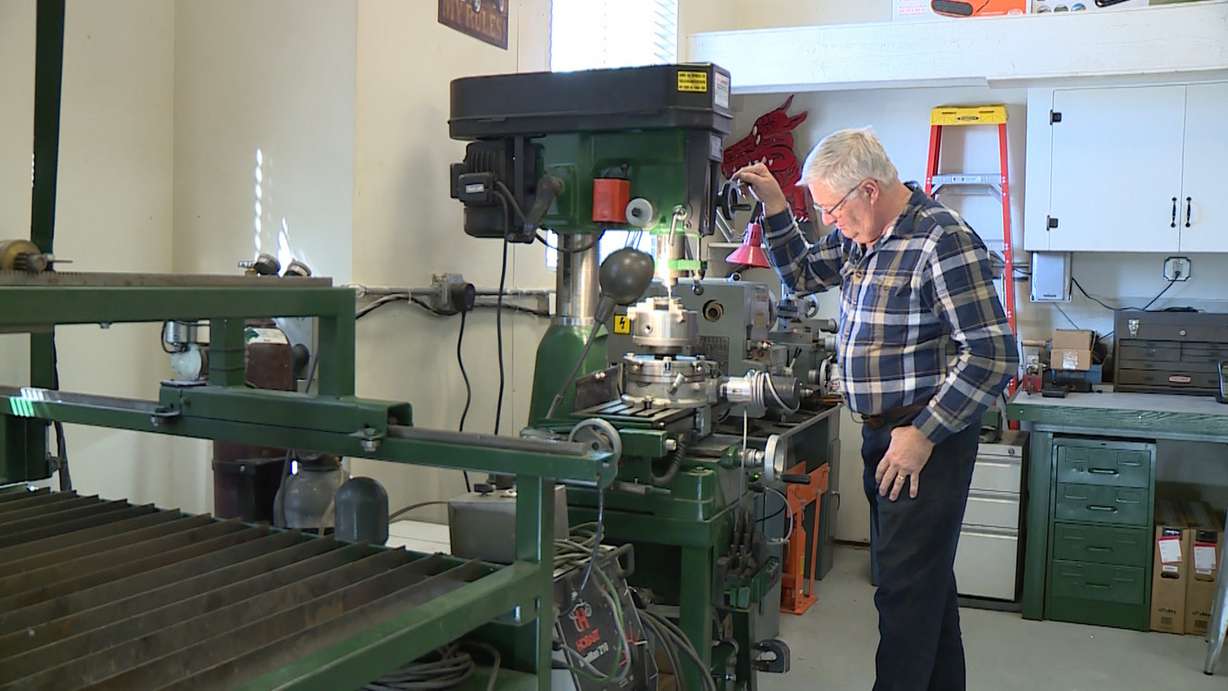 Reid Haroldsen drills holes in one of the main rotor pieces for an Enigma machine. (Photo: Ray Boone, KSL TV)