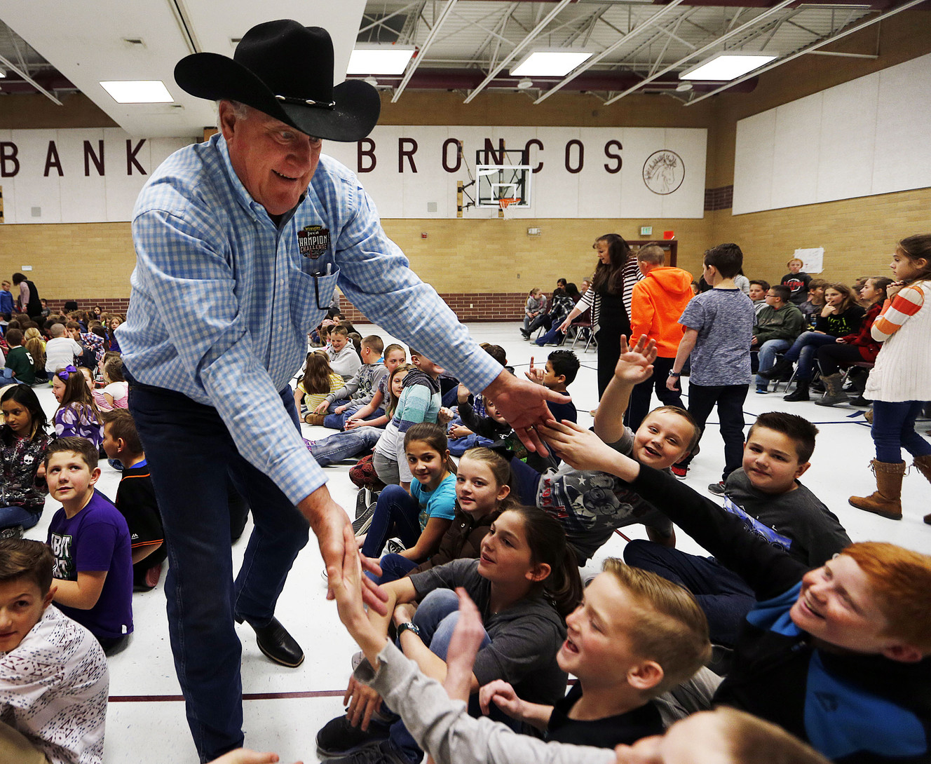 Wayne Andersen, of the Spanish Fork Rodeo committee, greets students during the Champion Challenge Rodeo Assembly at Brockbank Elementary School in Spanish Fork on Monday, Feb. 27, 2017. The challenge encourages students to read. (Photo: Ravell Call, Deseret News)