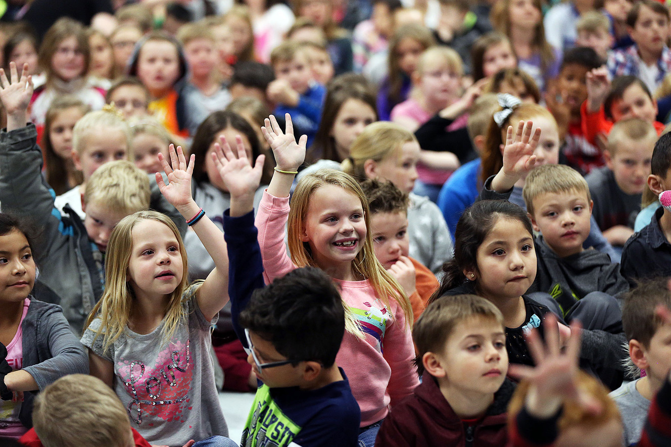 Students raise hands to ask questions during the Champion Challenge Rodeo Assembly at Brockbank Elementary School in Spanish Fork on Monday, Feb. 27, 2017. The challenge encourages students to read. (Photo: Ravell Call, Deseret News)