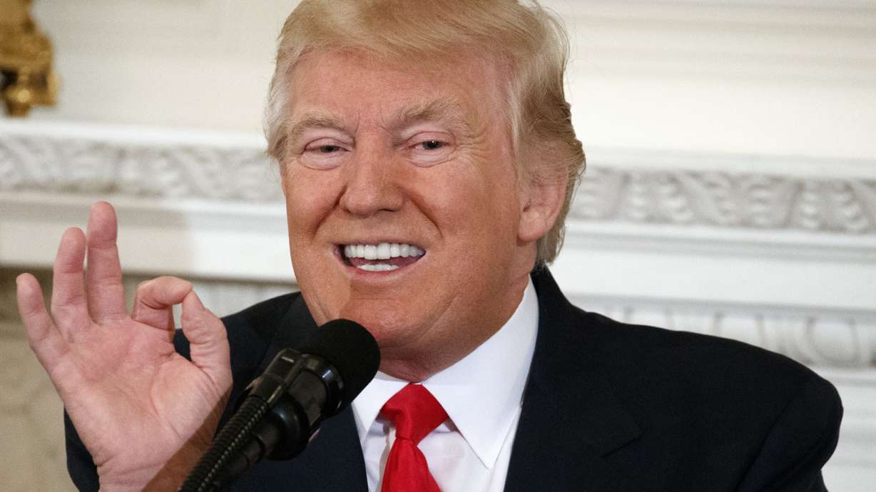 The Latest: Trump signs order loosening gun restrictions