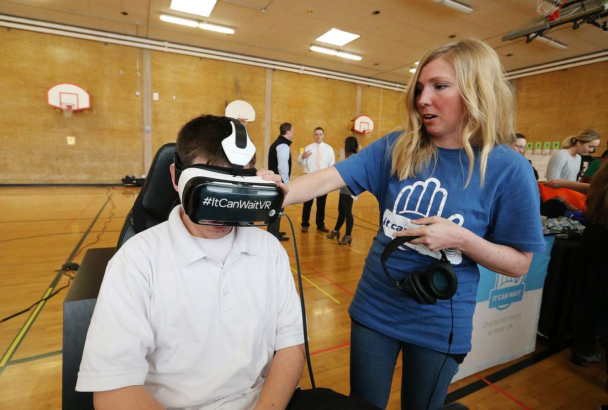Jill Maguire helps Hillcrest High School student Caleb Stanger try a virtual reality simulator. Photo: Jeffrey D Allred, Deseret News
