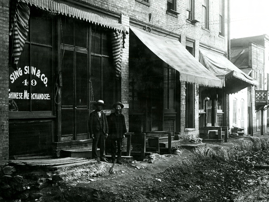 Two men stand outside a Plum Valley business on Aug. 24, 1907. (Photo: Utah Division of History)
