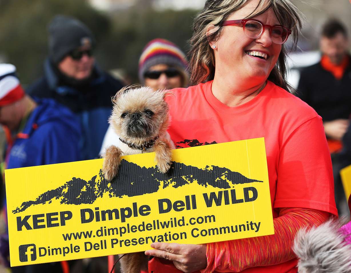 Organizer Monica Zoltanski and her dog Chewie join in as a group that opposes pavement of a trail in Dimple Dell Regional Park gather for a rally on Saturday, March 4, 2017. (Photo: Scott G Winterton, Deseret News)