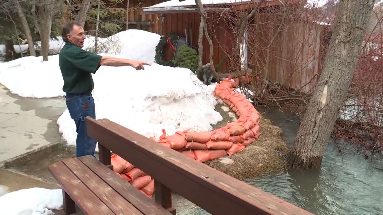Keith Rounkles. who runs The Oaks restaurant in Ogden Canyon, points to the high water level of the Ogden River running near his property. (Photo: Tanner Siegworth, KSL TV)