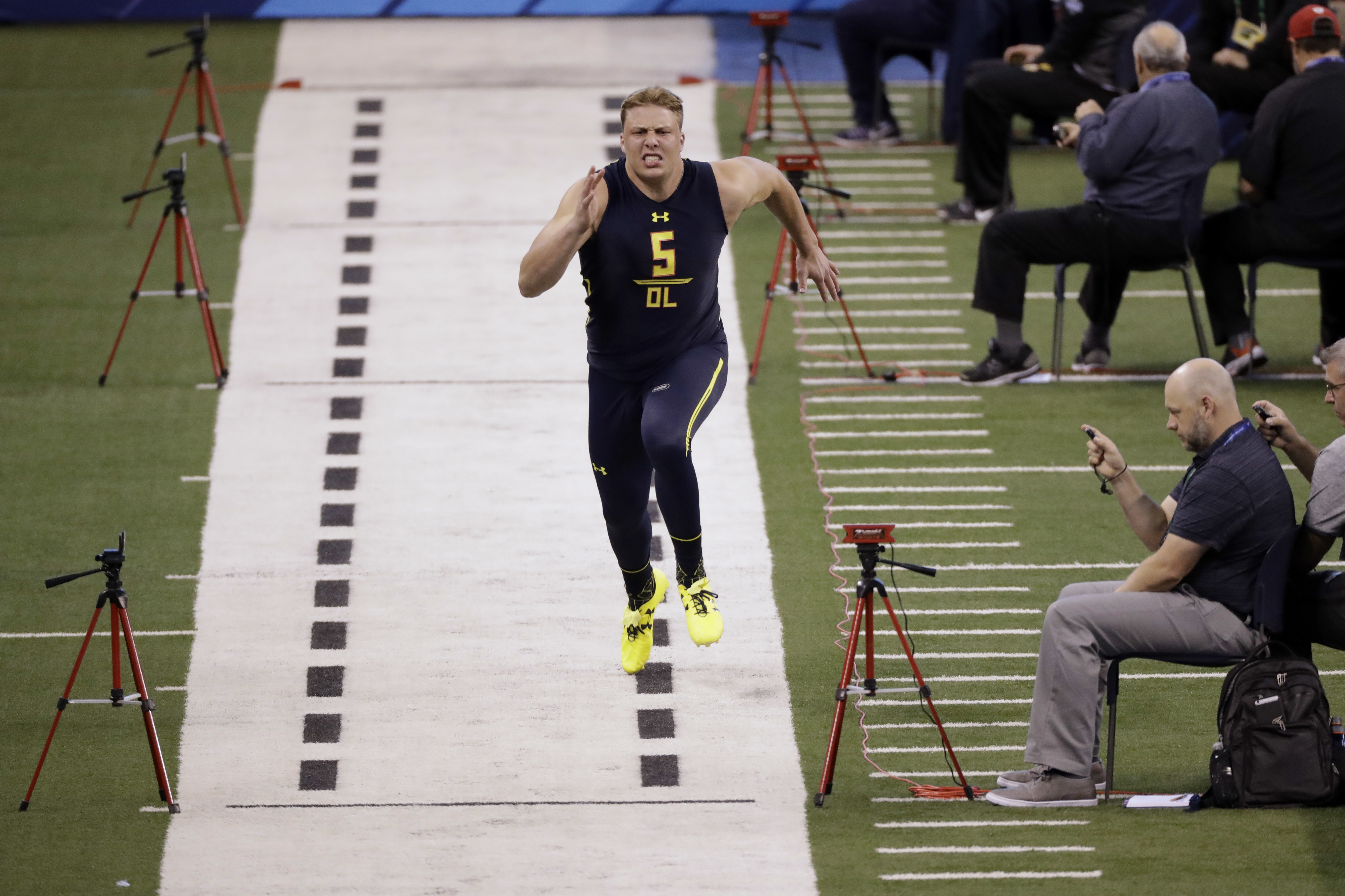 Utah offensive lineman Garett Bolles runs a drill at the NFL football scouting combine in Indianapolis, Friday, March 3, 2017. (AP Photo/Michael Conroy)