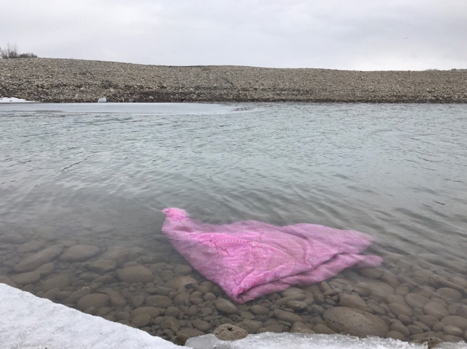 A blanket was floating in the pond Tuesday where the accident happened. (Photo: Stephan Rockefeller, EastIdahoNews.com)