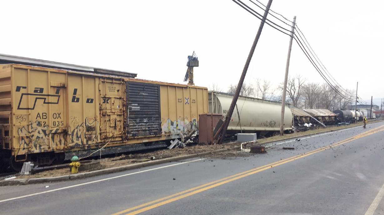 Crews removing derailed freight train with hazardous load