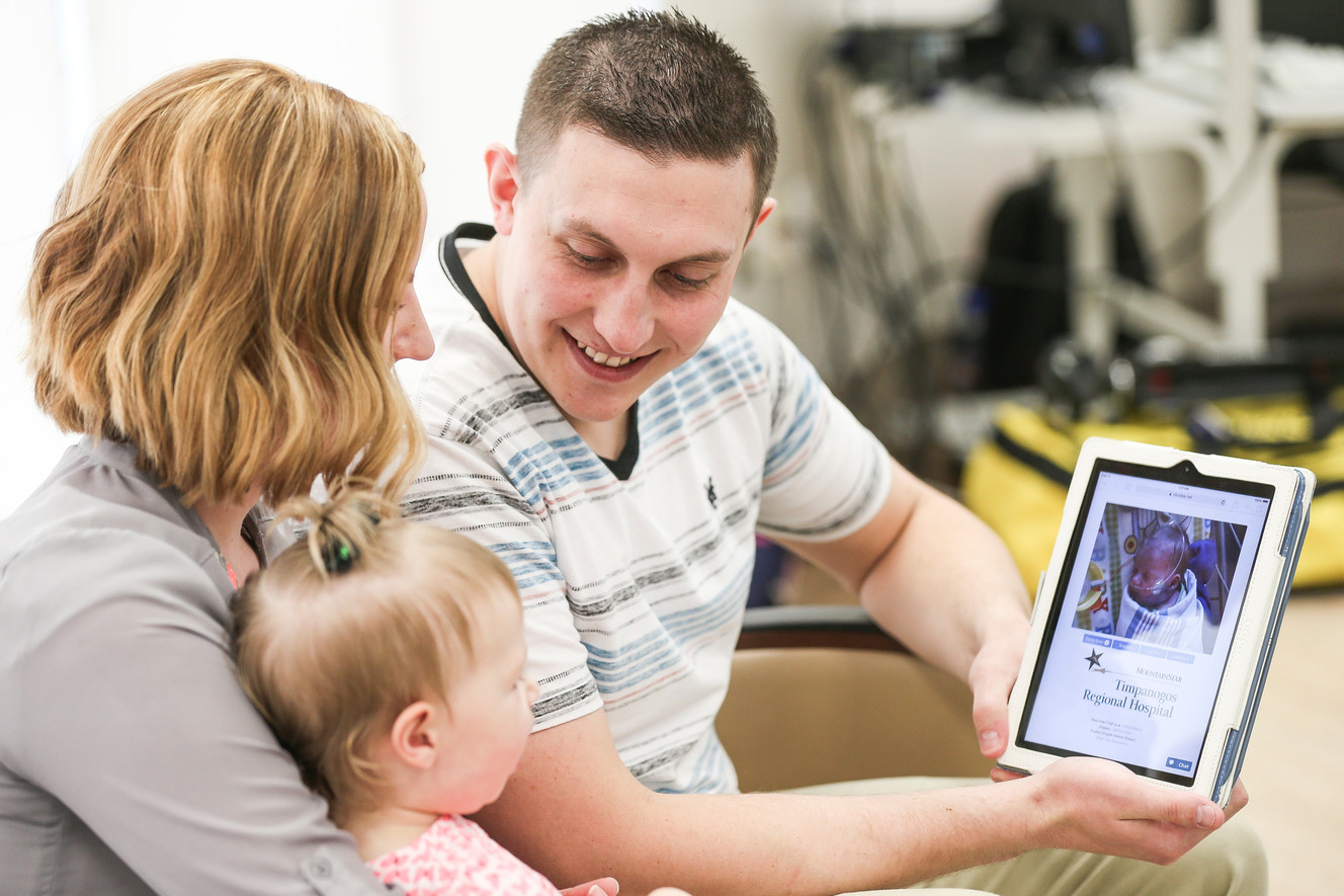 Michaela and Zach Evans, with their 1-year-old daughter Mackley, demonstrate the use of a webcam to check in on their infant son, Zaden, who is in the neonatal intensive care unit, at Timpanogos Regional Hospital in Orem on Wednesday, March 8, 2017. Photo: Spenser Heaps, Deseret News