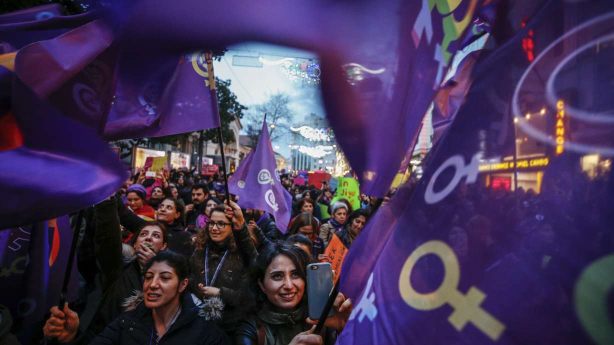 AP PHOTOS: On Women's Day, many rally, skip work, wear red