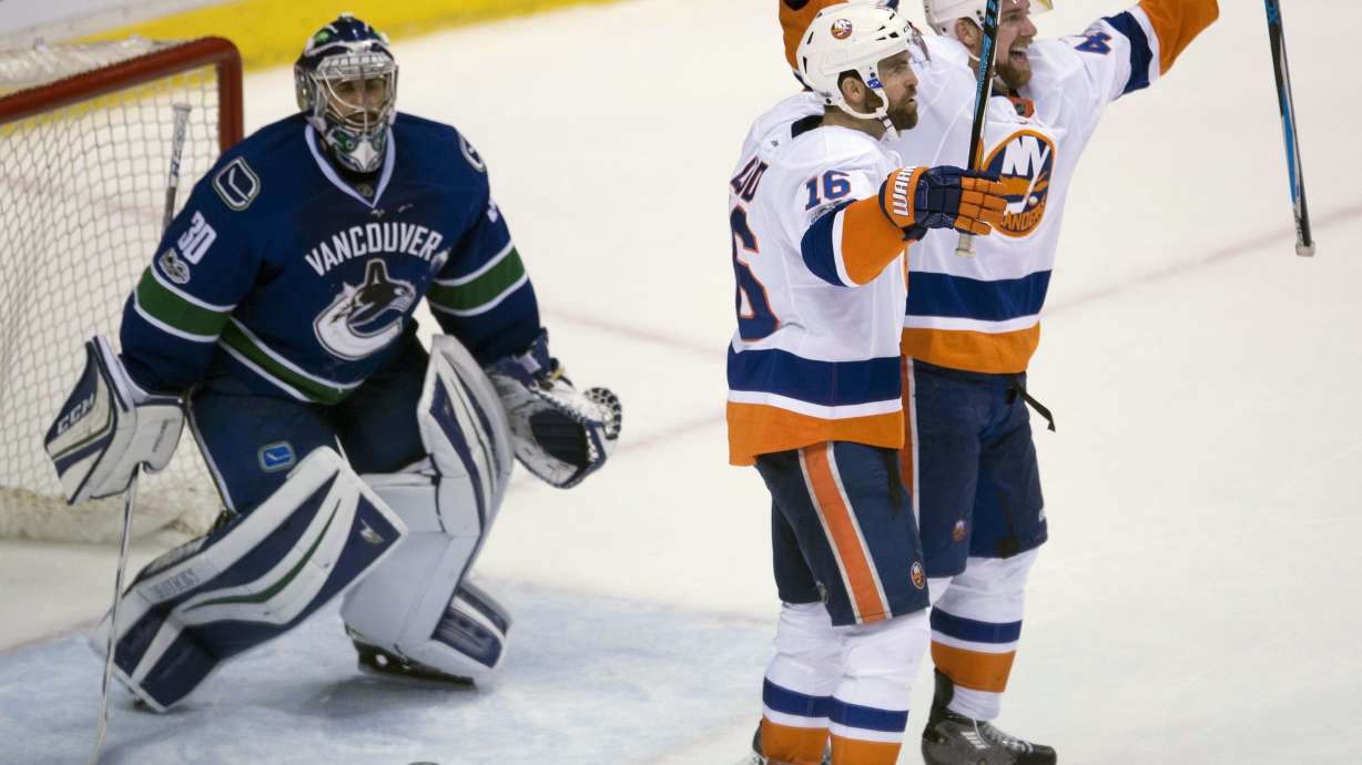 Ladd scores in OT and Islanders top Canucks 4-3